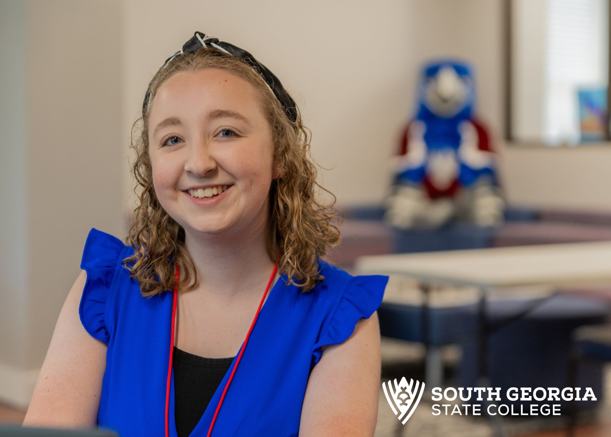 student sitting with Hawk in background